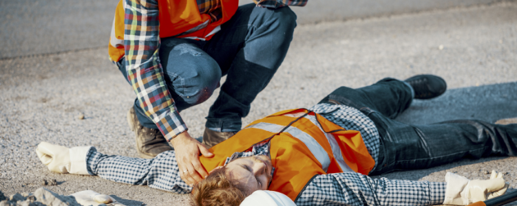 Construction worker lying on ground after accident