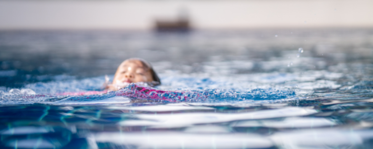 Child swimming in large body of water