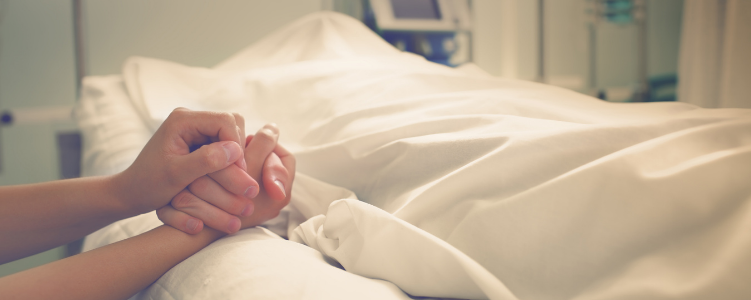 Holding hands over hospital beds